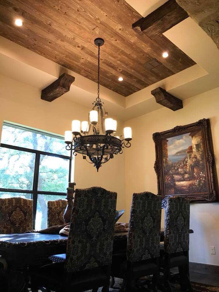 Formal dining room with wood-beamed ceiling and wrought iron chandelier